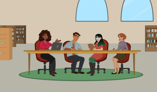 A diverse group of library workers sitting at a table and smiling at the camera. 