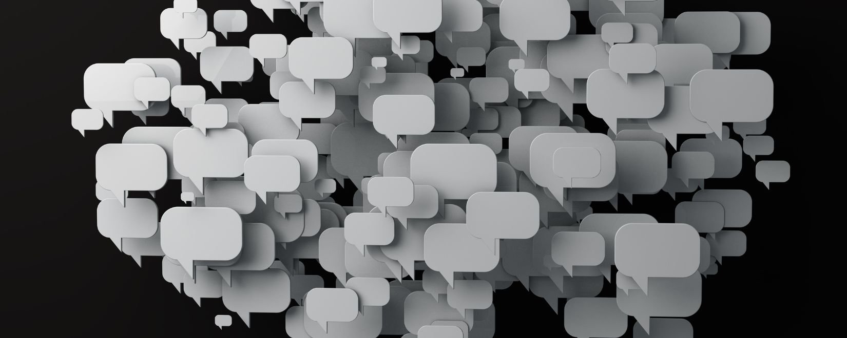 A cluster of white talk bubbles on a black background
