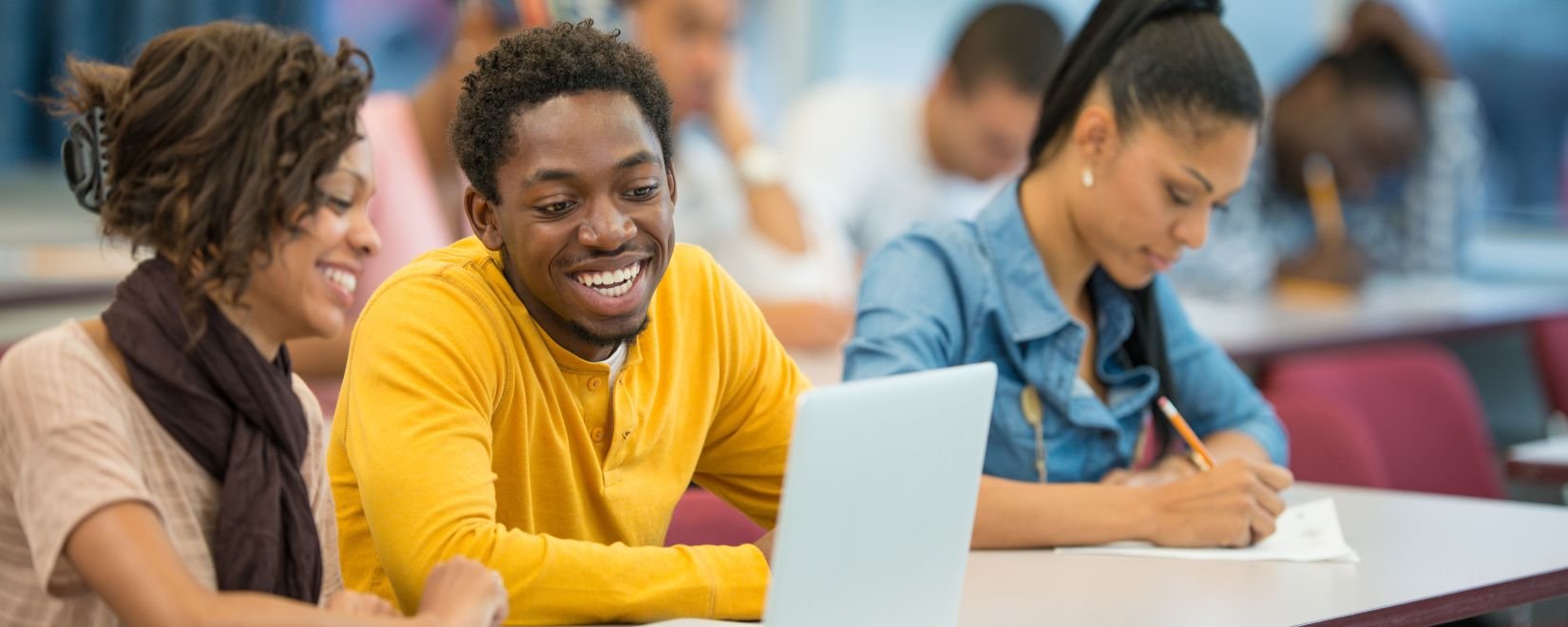 Three African-American college students in a classroom
