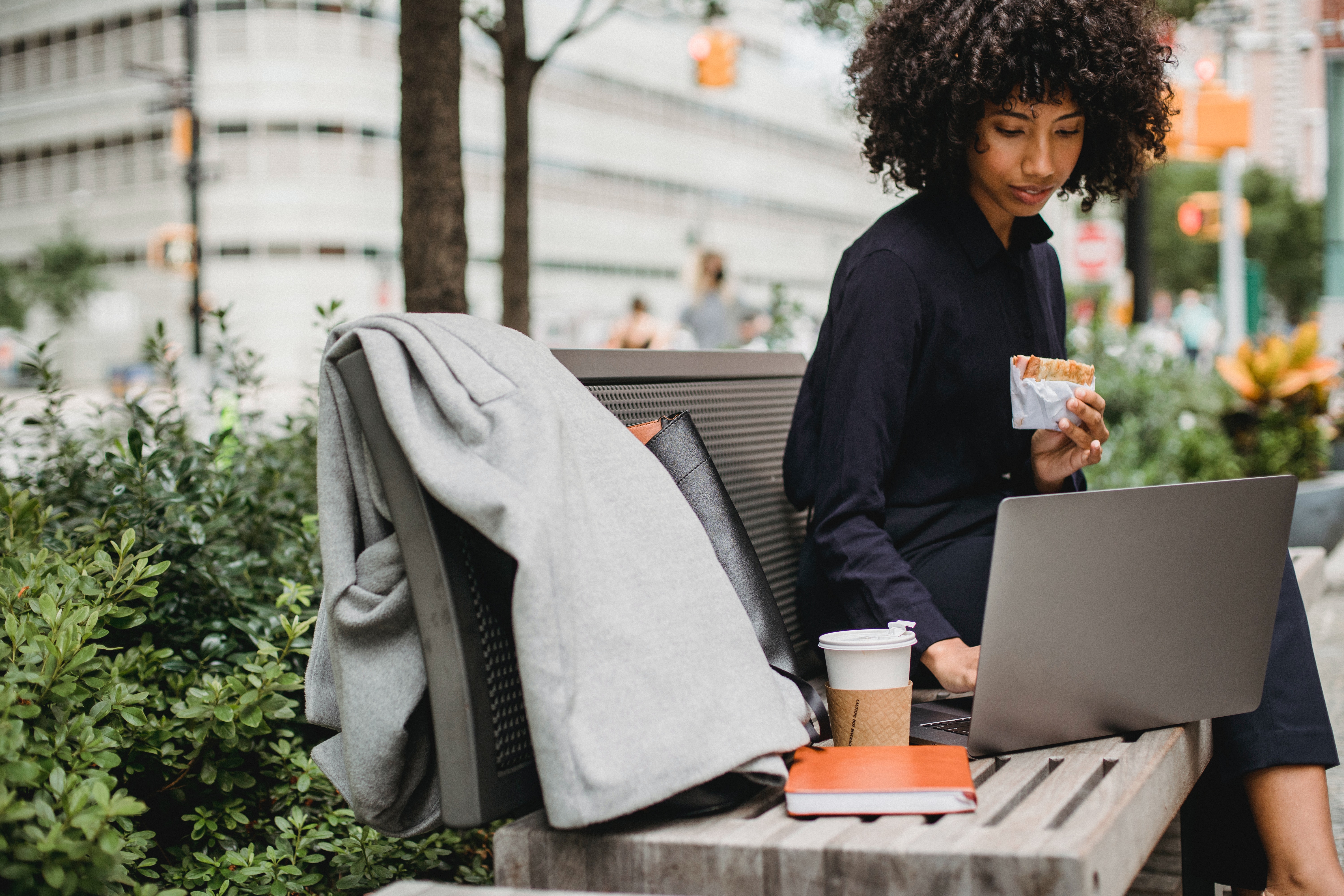 african american woman enjoying lunch break watching content