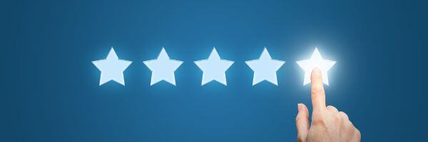 Five rating stars with a hand clicking the fifth star and lighting it up