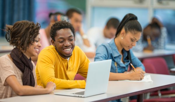 Three African-American college students in a classroom