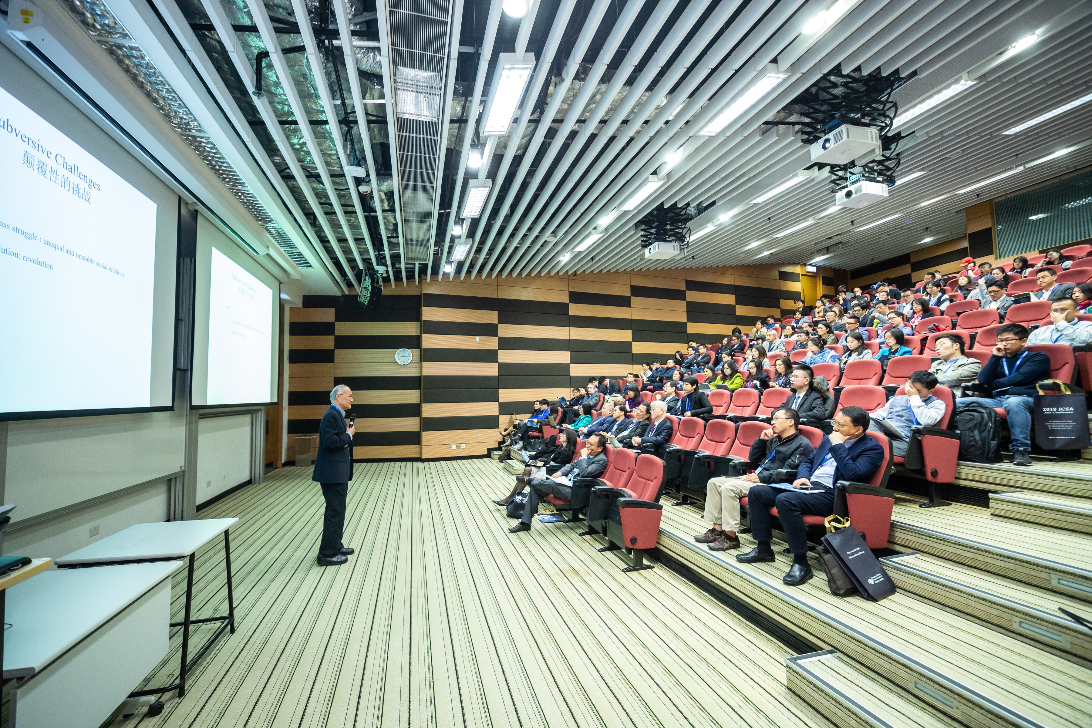 Speaker delivering a talk during department event.